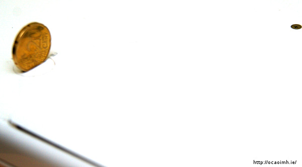 Open the Macbook battery compartment with a coin